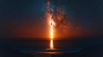 The rocket ascends into the night sky, leaving a bright trail of fire over the ocean, highlighting the power of modern aerospace technology and innovative recovery methods during launch. photo