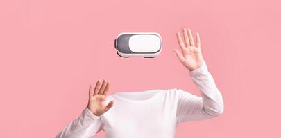 A user wearing a virtual reality headset interacts with an immersive environment. The person is isolated against a pink background, hands raised in a virtual experience. photo