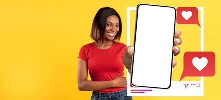 A smiling influencer holds a smartphone displaying a blank screen, surrounded by messaging icons and hearts. The bright yellow background enhances the lively social media theme. photo