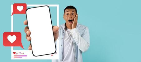An influencer expresses excitement while holding a smartphone with a blank screen. Colorful heart icons and speech bubbles suggest social media interaction and online messaging. photo