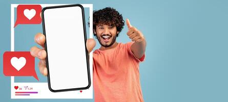 A social media influencer enthusiastically displays a smartphone with a blank screen, symbolizing online engagement. They are conveying positivity, ready to connect with their audience. photo