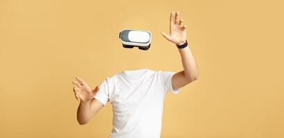 A person wearing a virtual reality headset engages with the technology, appearing without a visible head or face. The isolated environment emphasizes the immersive experience of modern VR. photo
