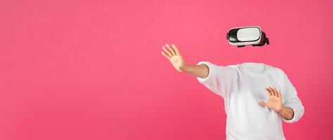 A person is engaging with virtual reality technology using a headset, fully immersed in a digital environment. The vibrant background enhances the technological ambiance. photo