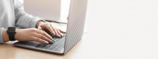 Telecommuting And Freelance Concept. Closeup cropped view of unrecognizable woman using computer, typing on laptop keyboard, writing report, sitting at desk, selective focus. People And Technology photo