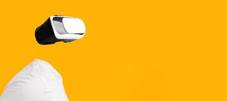 A user engaged in virtual reality without visible head or face, immersed in augmented reality. The bright yellow background enhances the futuristic feel of this technology-driven experience. photo