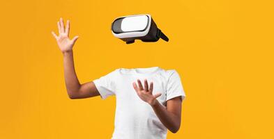 A person engages with virtual reality using a headset, their body visible but headless, against a vibrant yellow background, showcasing the power of immersive technology and modern devices. photo