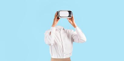 A user engages with a virtual reality headset, experiencing technology without visible identity. They are in a simple, isolated environment, emphasizing the gadget's modern appeal. photo