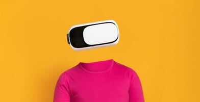 A person wearing modern virtual reality goggles engages with technology. The vibrant yellow background enhances the focus on the headset, capturing the essence of immersive experiences. photo