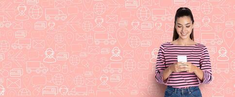 A young woman is engaged in online shopping using her smartphone, smiling as she browses through an application. The background features a collage of delivery and commerce symbols. photo