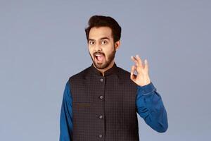 Expressing positivity. Happy Indian guy showing okay gesture over lilac background, panorama photo