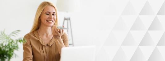 Audio Message. Woman Using Phone, Working On Laptop In Office, copy space photo