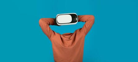 This modern user interacts with advanced virtual reality technology, focusing on immersive experiences. The vibrant background emphasizes the gadget's sleek design and its transformative potential. photo