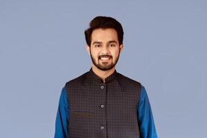 Handsome millennial man of Indian origin smiling over lilac background photo