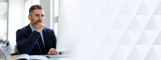 Middle aged businessman in a suit sits at his desk, deep in thought, contemplating decisions in a well-lit, modern office environment with ample copy space available, copy space photo