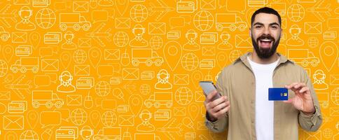 A happy buyer showcases his smartphone and payment card while engaging in online shopping. The vibrant background features icons related to delivery and e-commerce, creating a dynamic atmosphere. photo