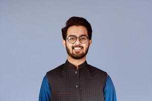 Smiling Indian man wearing stylish glasses on lilac background photo