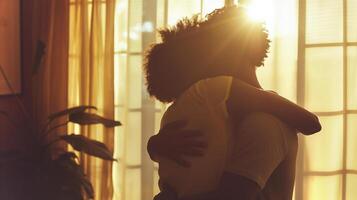 This Two people embrace warmly, resolving their conflict in soft sunlight and shadows. photo