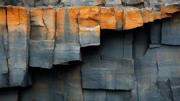 Massive rock formations exposed in a quarry reveal distinct layers of minerals, highlighting the extraction process and geological structure present in the area. photo
