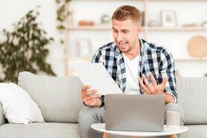 Bad News And Money Problem. Man Screaming And Gesturing While Reading Mail Letter Or Debt Notification photo