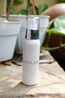 A bottle of facial wash sitting on a table photo