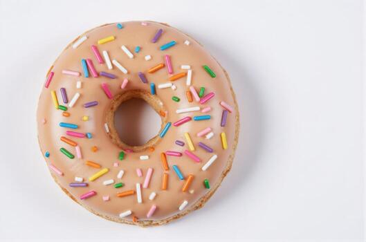 A donut with sprinkles on top of a white background photo