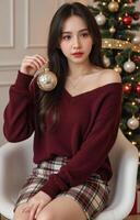 A woman in a red sweater and skirt holding a christmas ornament photo