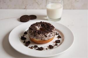 A donut with oreo cookies and milk on a plate photo