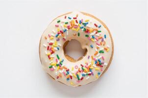 A frosted enjoyment donut with sprinkles on a white background photo