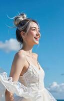 A woman in a wedding dress standing on the beach photo
