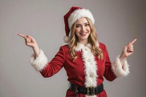 A beautiful young woman in santa claus outfit pointing at something photo