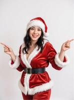 A woman in santa claus suit pointing at something photo