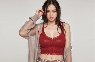 A woman in wet a red bra top and cardigan photo
