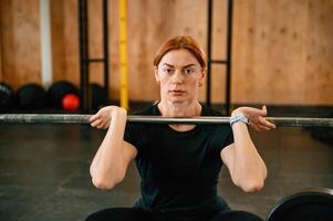 Lifting the barbell. Beautiful strong woman, is in, the gym photo