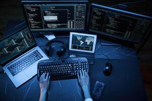 Close up top view of female hacker hands, typing on keyboard, photo