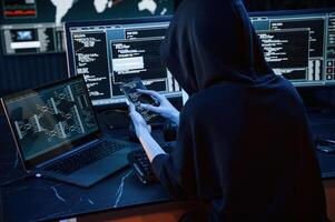 Modern ,technology. .Young professional female hacker is indoors by computer with lot of information on displays photo
