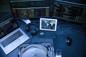 Top ,view. Young ,professional female hacker is indoors by computer with lot of information on displays photo
