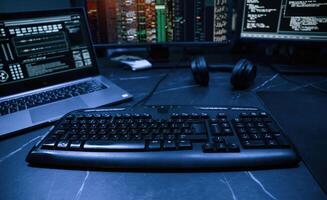 Keyboard ,and screens. Cyber criminal haker dark room for massive attack of corporate big data servers photo