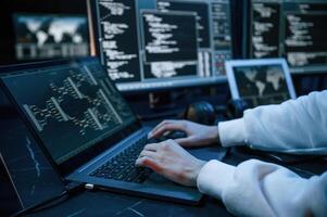 Side close up view of female ,hacke,r hands, typing on keyboard photo