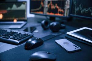 Financial Analyst Working on, a Computer with MultiMonitor Workstation with Real-Time Stocks, Commodities and Exchange Market Charts. photo
