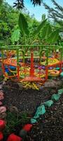 A colorful swing in a tropical garden photo