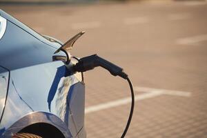 Close up view ,of the modern electric car that is charging photo