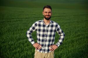 On agricultural field... Handsome, young man photo