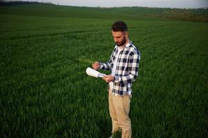 Spring, season.. Handsom,e young man is on agricultural field photo
