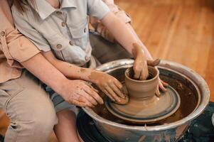 Close up ,view. Mother with little girl doing pottery at home photo