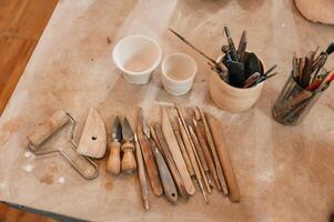 Pottery tools.. Close up view of the table with instruments photo