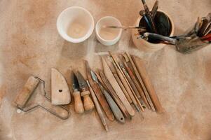 Pottery, tools. Close up view of the table with instruments photo