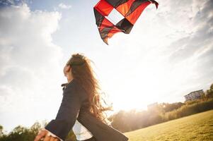 Beautiful, sunlight.. Happy, little girl is playing with kite on the summer field photo