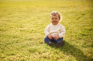 Little, girl, in casual clothes is on the summer field photo