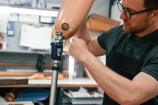 Twists, the hexagon. Technician working with prosthesis in modern laboratory photo