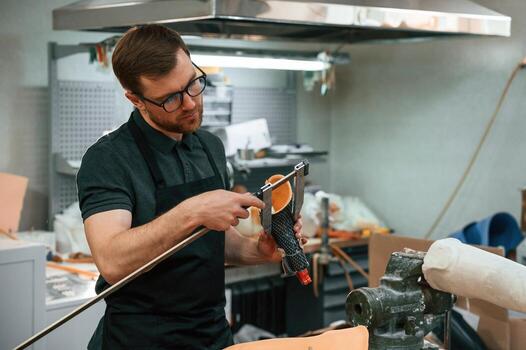 Measures the, diameter ,of the prosthesis.. Technician working in modern laboratory photo